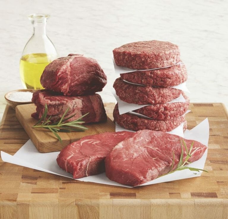 Black Angus combo pack featuring steaks and burgers on a wooden cutting board, ready to be cooked.
