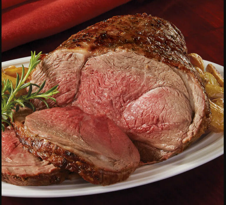 Leg of Lamb with French fries on a while platter