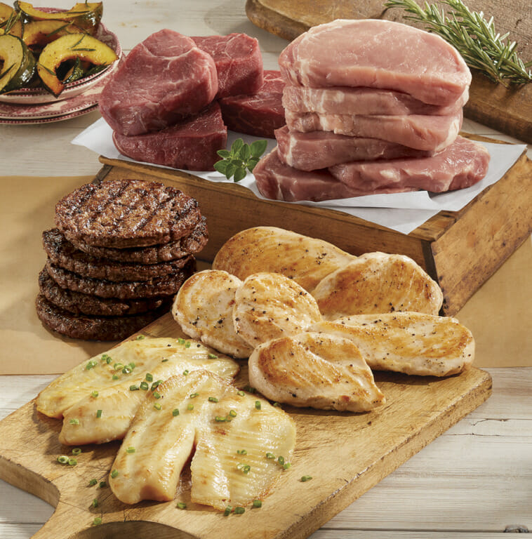 A 24 piece variety of meats, including pork chops, steak, hamburgers, chicken breasts and fish filets.