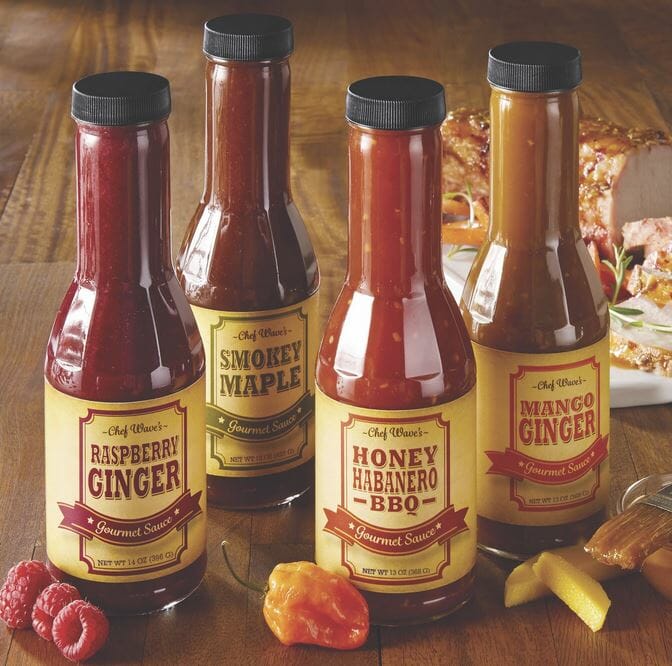 Four bottles of sauce including Raspberry Ginger, Smokey Maple, Honey Habanero BBQ, and Mango Ginger.