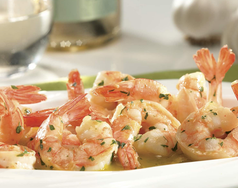 Buttery Shrimp Scampi in a white serving dish, garnished with parsley.